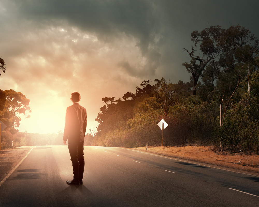 Rear view of businessman standing on road